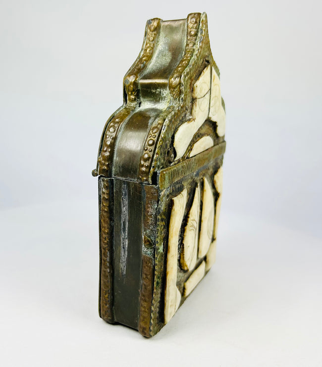 19th century Berber tribal amulet holder, brass repoussé work with protective geometric symbols.