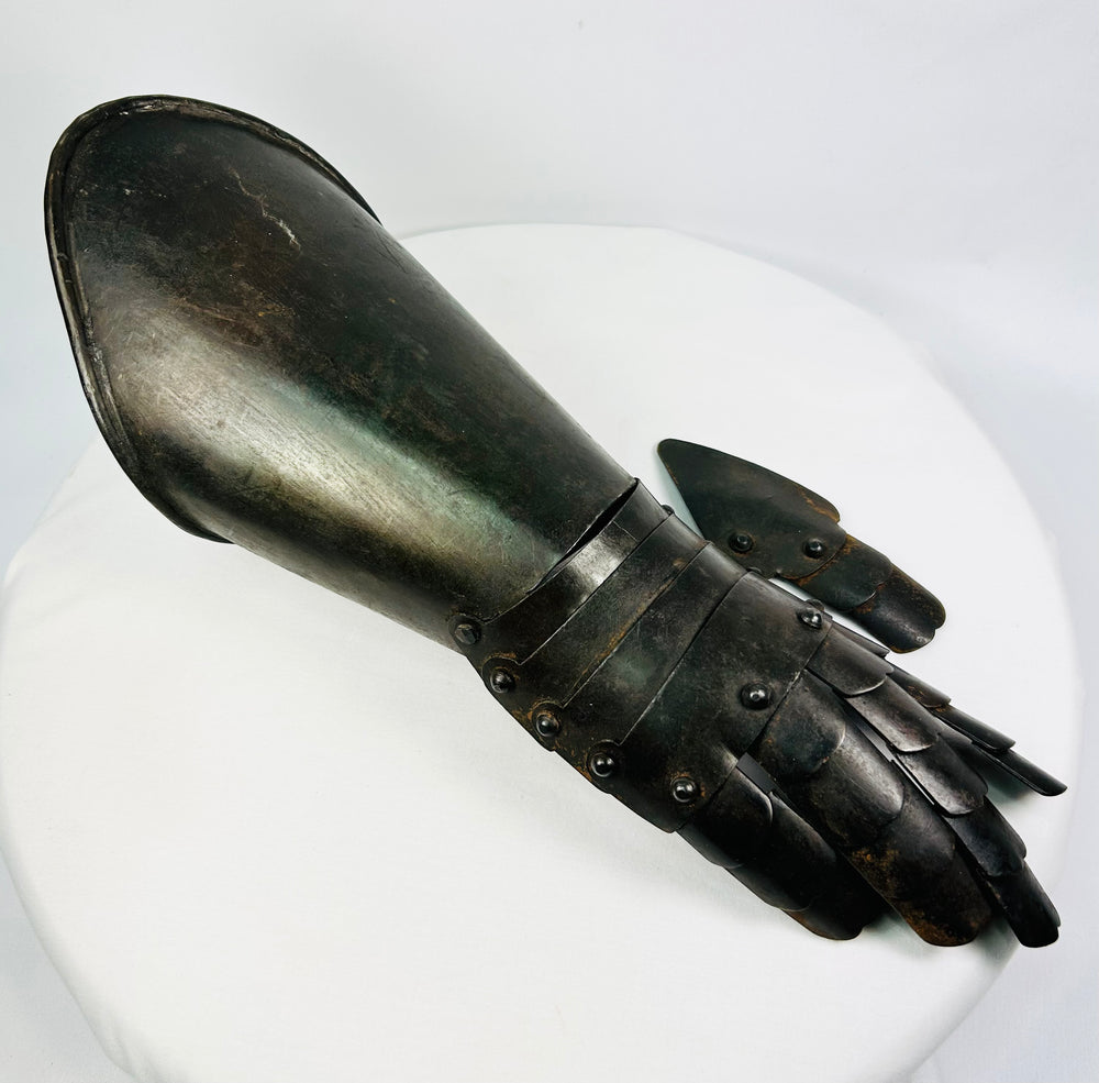 Right-hand articulated steel gauntlet photographed on white background with visible wrist lames and finger plates.