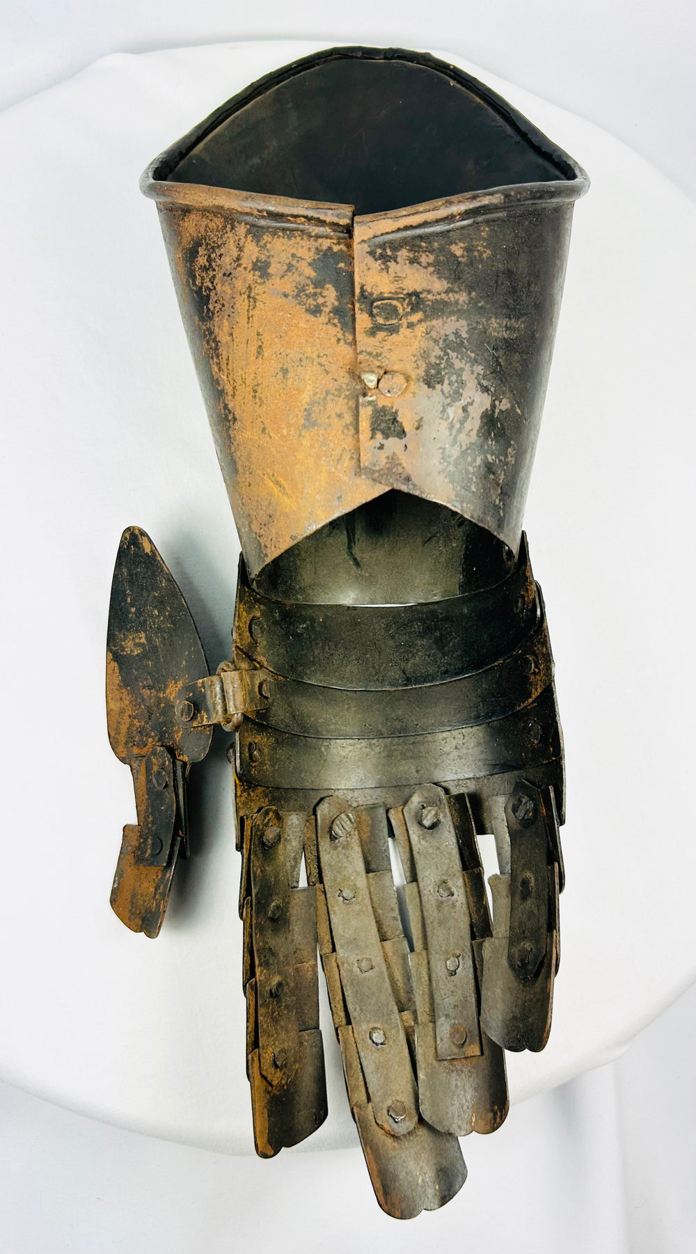 Antique-style hand defence gauntlet showing articulated knuckle plates and natural patina.