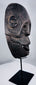 Circa 1930 tribal mask from West Timor carved from a single piece of hardwood and mounted for display.