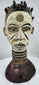 Igbo wooden Janus crest with white, black, red, and purple pigments used in ceremonial performances.