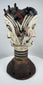 Traditional Igbo masquerade crest with opposing faces, projecting coiffure elements, and aged patina.