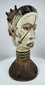 Hand-carved wooden Janus dance crest from Nigeria showcasing ritual symbolism and painted geometric motifs.