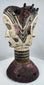Mid-century Igbo masquerade headdress featuring a carved Janus head design and weathered surface patina.