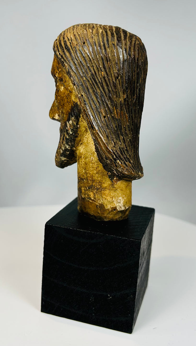 Fragment of religious sculpture depicting Christ with solemn expression