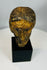 Antique carved Christ head with worn paint and textured surface