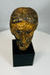 Antique carved Christ head with worn paint and textured surface