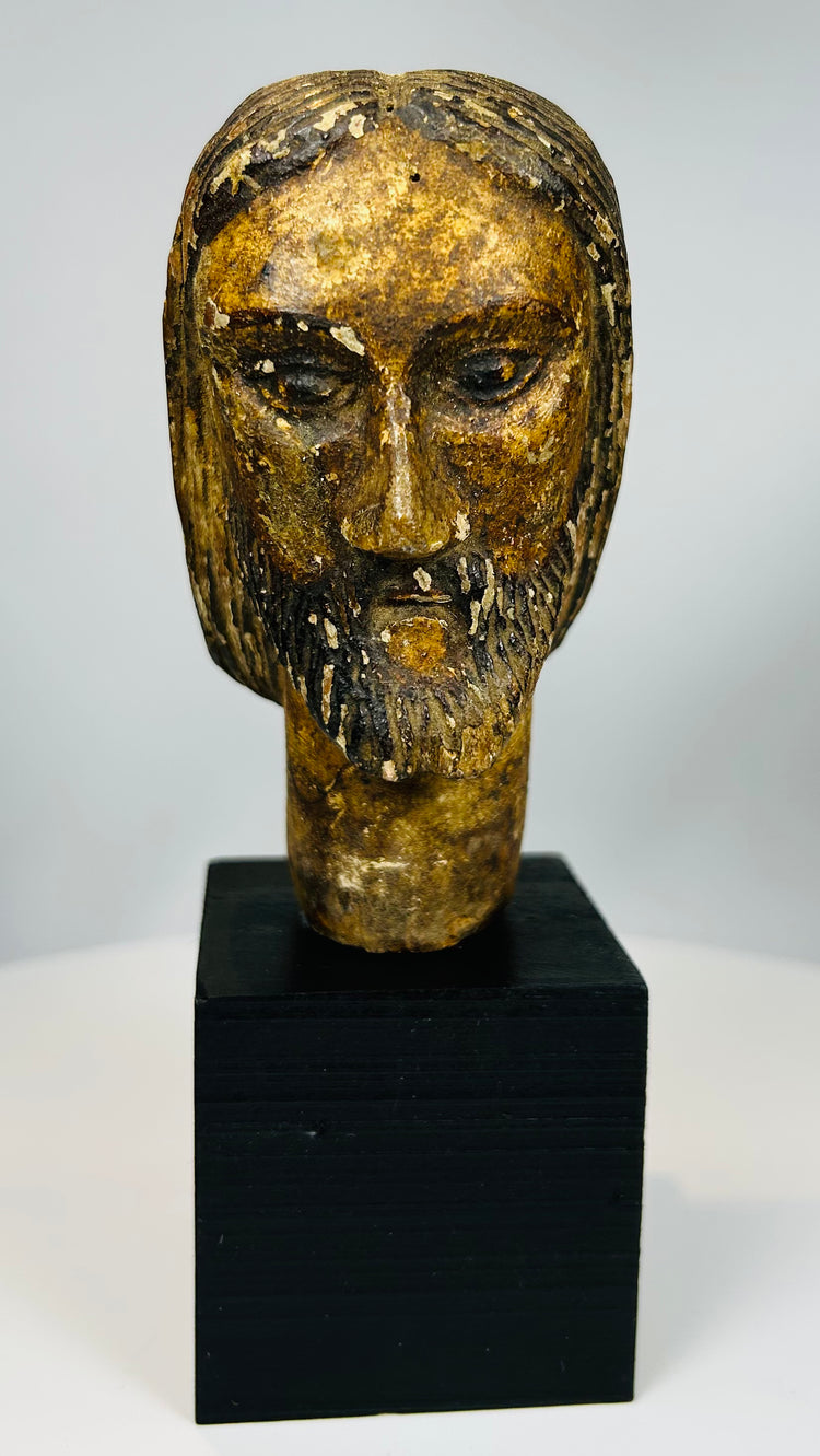 Carved wooden Christ head with expressive facial features