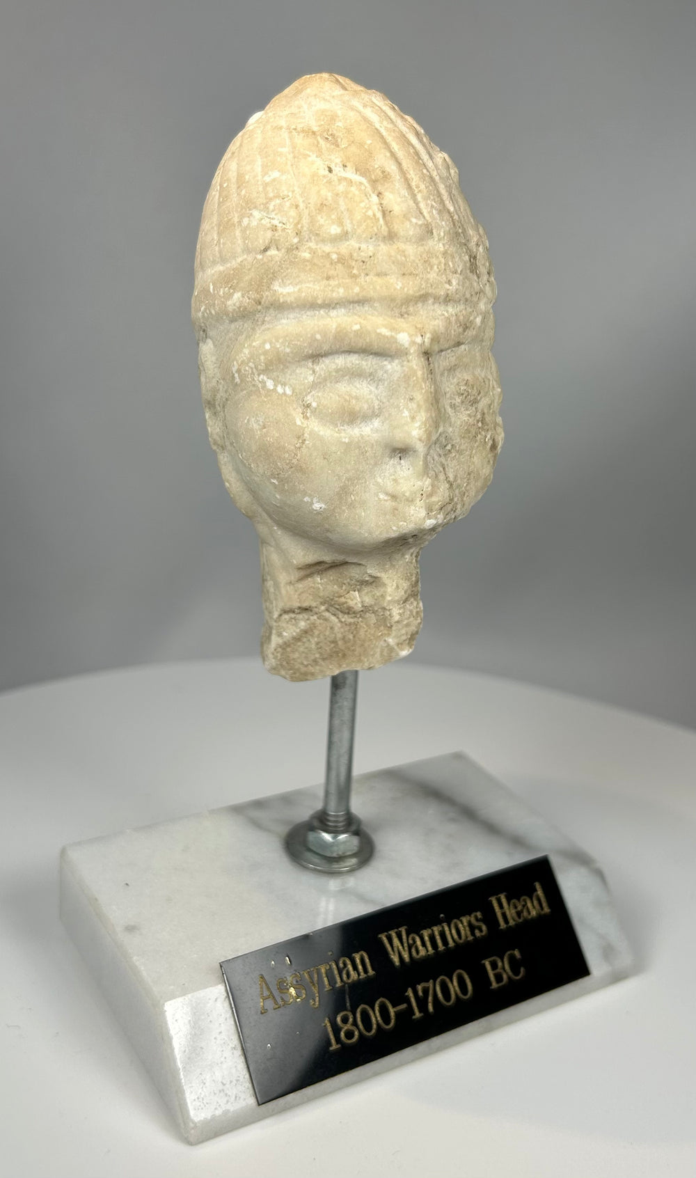 Fragment of Assyrian warrior head with carved helmet detail