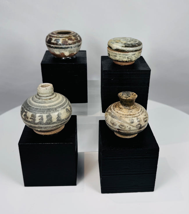 Ancient Thai Sawankhalok ceramic vessels with iron-black painted motifs beneath a transparent glaze, dating to the 14th–15th century CE.