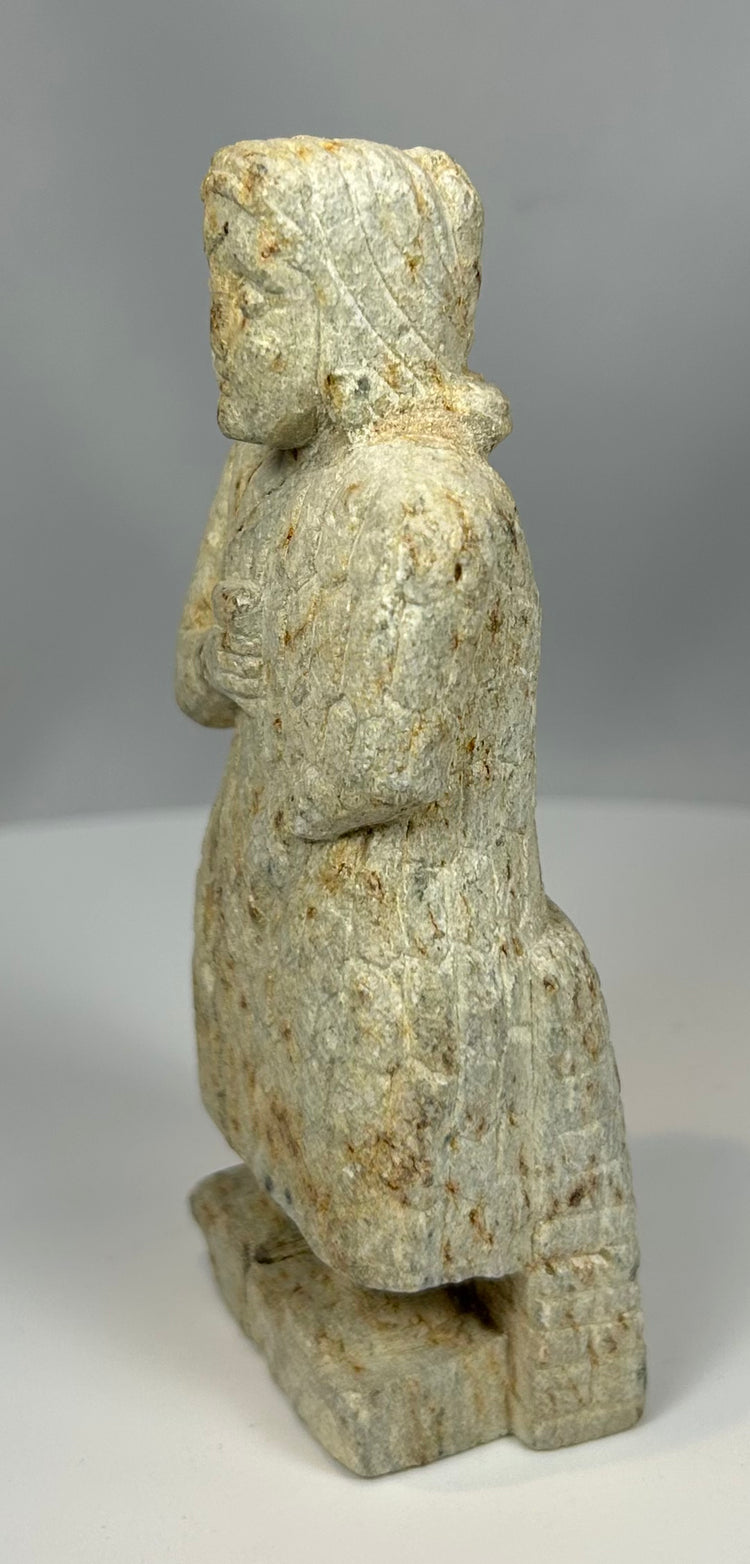 Stone figurine from Mesopotamia with stylized facial features
