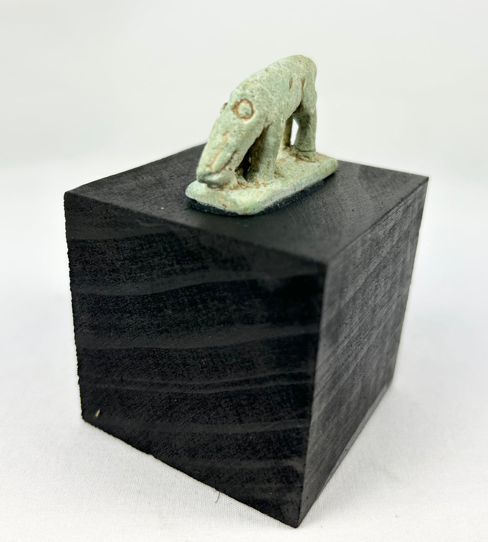 Ptolemaic Egyptian faience shrew figure on rectangular plinth with rear support strut and surviving green glaze.