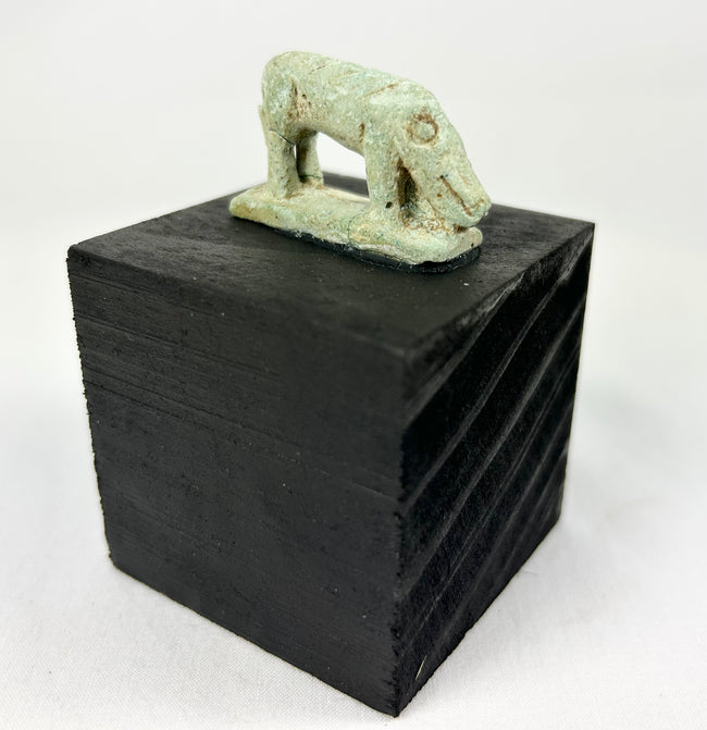 Ancient Egypt shrew-mouse amulet, pale green faience with mineral accretions, votive temple offering.
