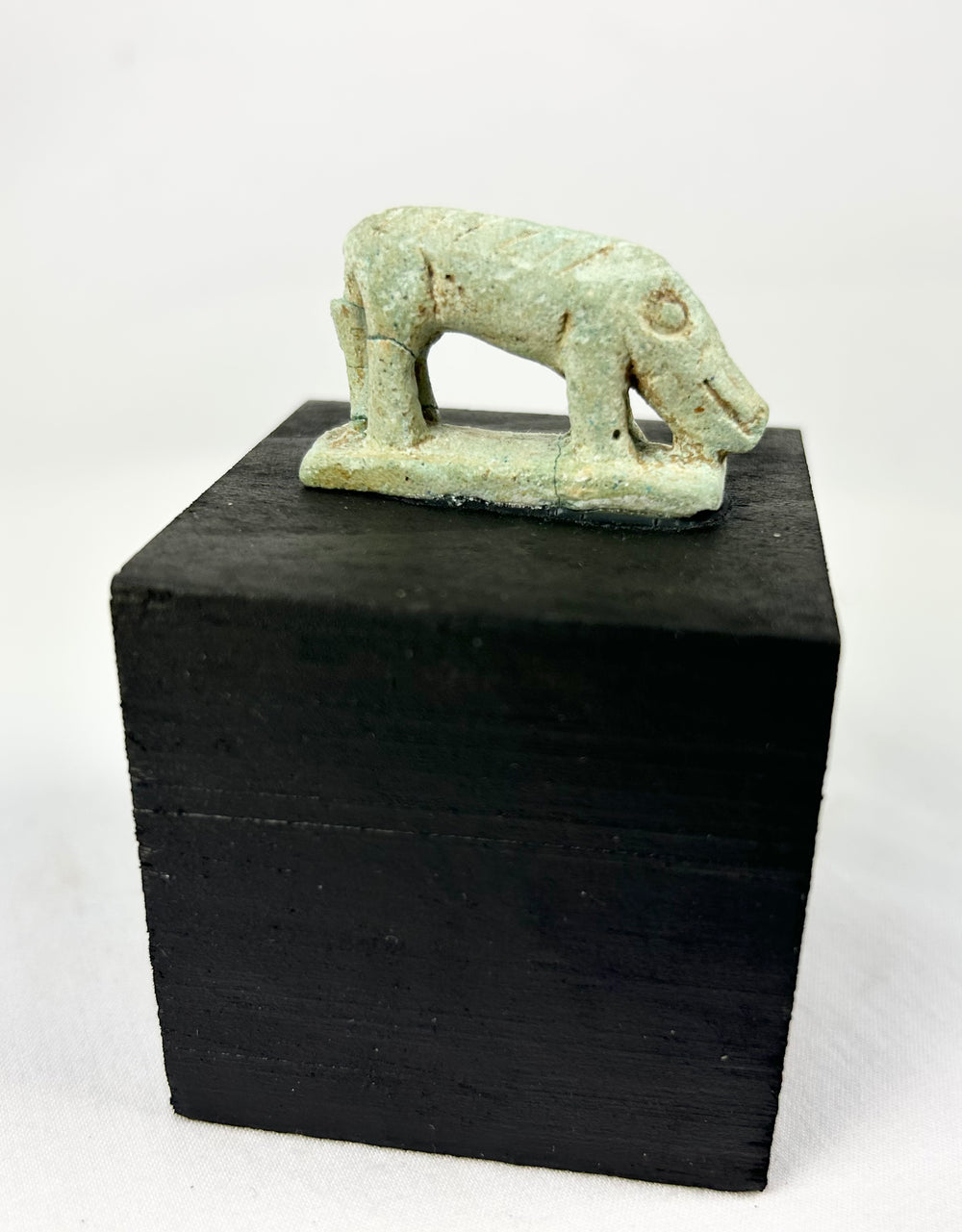 Late Dynastic Egyptian faience animal amulet, modeled as a shrew with incised coat lines and dorsal support.