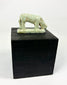 Small Egyptian faience shrew amulet from the Late Period, green glaze traces and archaeological patina.