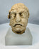 Carved limestone Bodhisattva head from ancient Gandhara with weathered facial features and archaeological surface patina.
