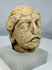 Rare Gandharan limestone fragment traditionally identified as Maitreya, showcasing the fusion of Greek, Roman, and Indian artistic styles.