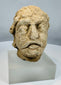 Weathered limestone head from ancient Gandhara representing a Bodhisattva figure from the Kushan to Post-Kushan period.