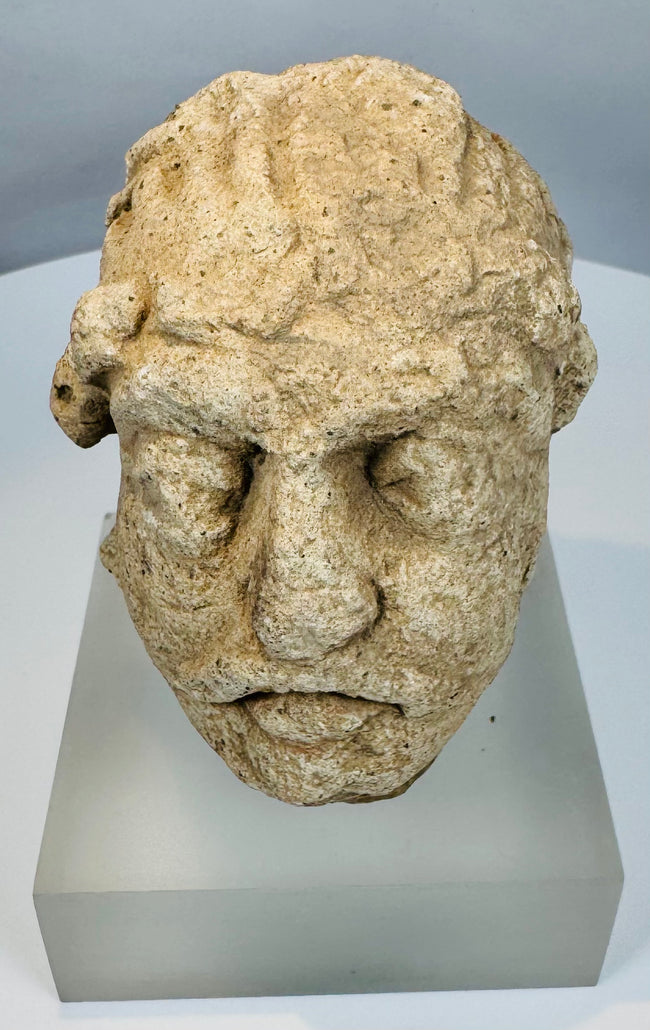 Silk Road era Gandharan Buddhist sculpture fragment carved from limestone and preserved with authentic archaeological wear.