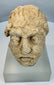 Silk Road era Gandharan Buddhist sculpture fragment carved from limestone and preserved with authentic archaeological wear.
