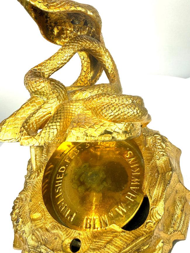 Mid-19th-century English cobra inkstand with aged gilt finish, naturally darkened bronze surfaces, and finely defined serpent scales.