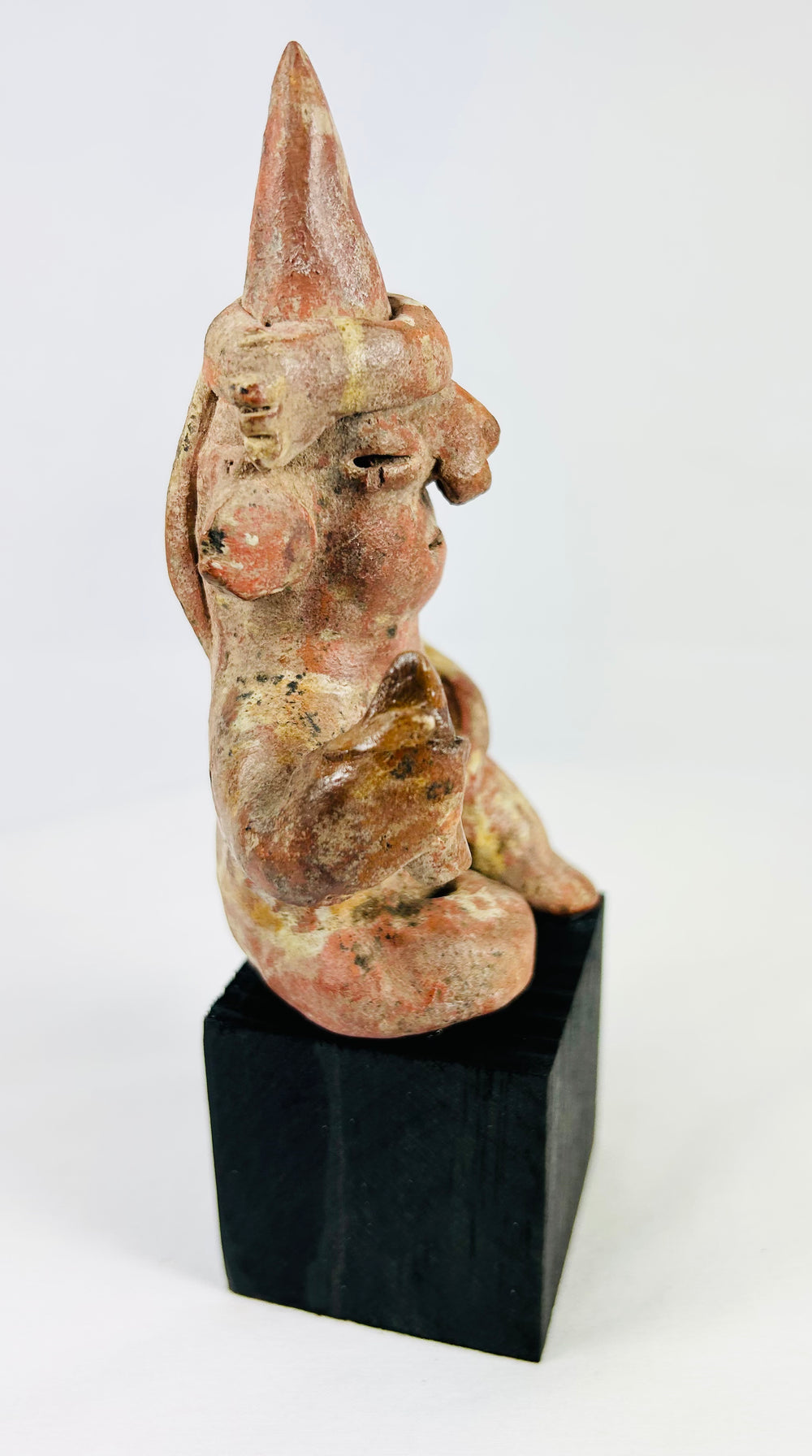 Museum display of a West Mexican Nayarit cone-cap ceramic figure