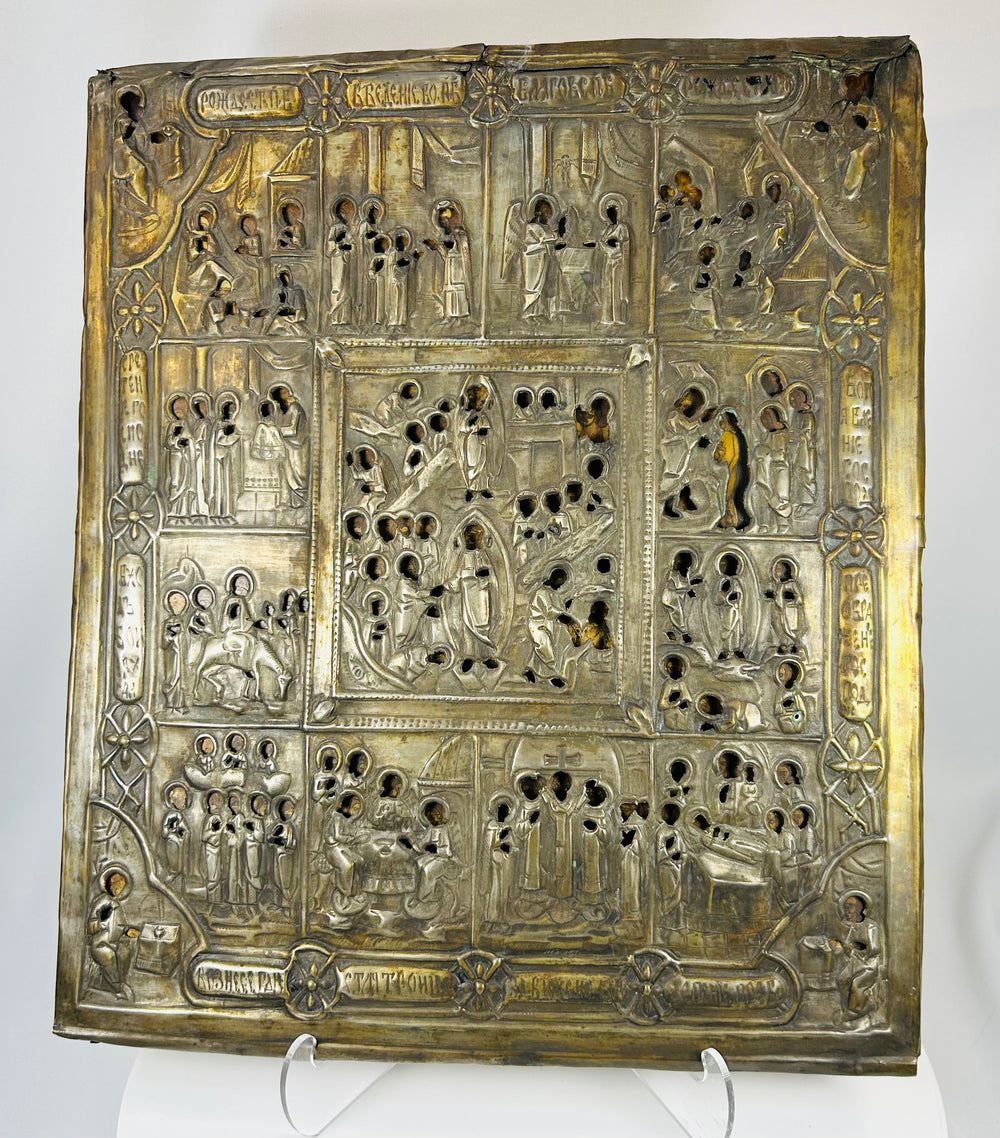 Multi-scene Russian religious icon with chased metal oklad and Church Slavonic inscriptions