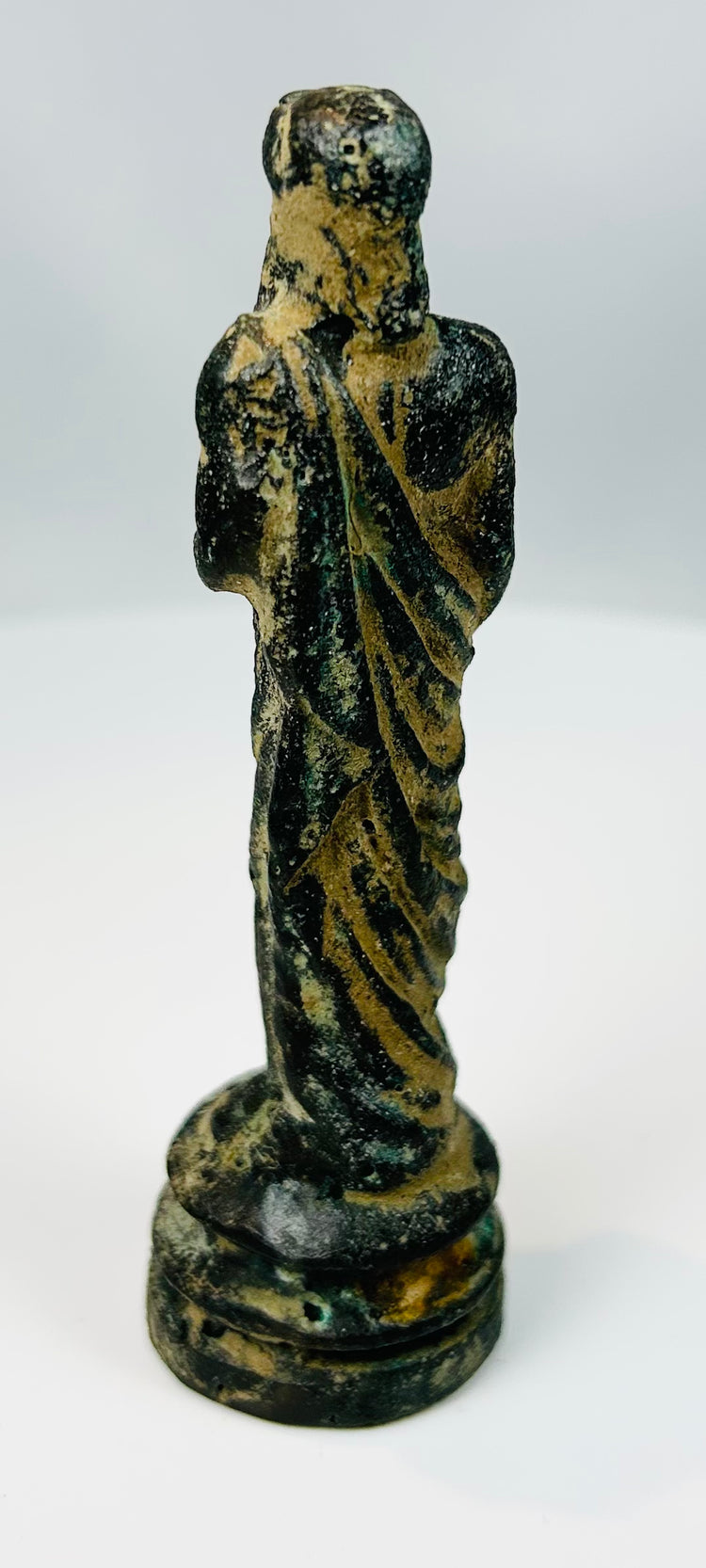 Classical revival bronze statue with detailed folds and compact form