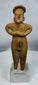 Hand-modeled Colima female figure showing folded-arm posture and traditional funerary symbolism.
