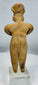 Pre-Columbian West Mexican terracotta female effigy with prominent ear ornaments and stylized facial features.