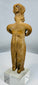 Colima gingerbread-style terracotta figure depicting a standing female with folded arms.