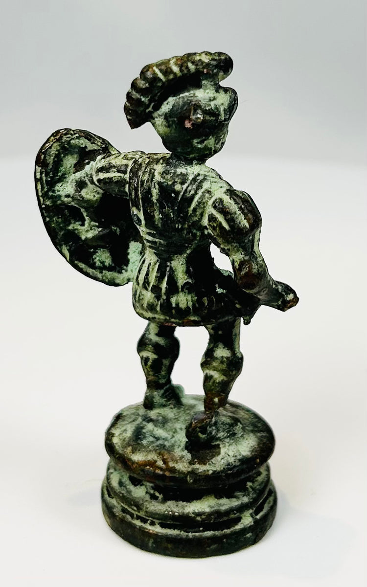 Antique bronze soldier figure with round shield and short tunic