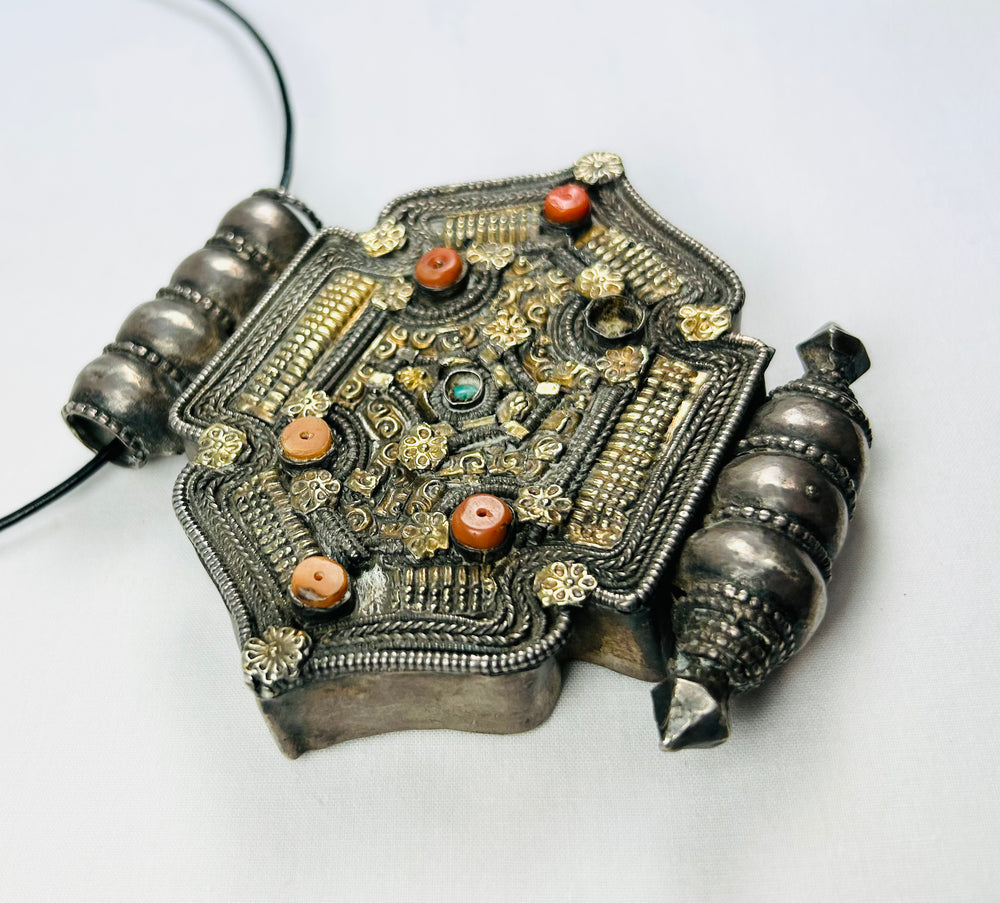 Himalayan gau amulet with silver-tone filigree, coral beads, turquoise cabochon, reliquary cavity