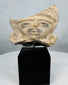 Pre-Columbian architectural or ceremonial terracotta fragment with expressive facial features and elaborate headdress.