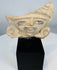 Ancient Veracruz-style terracotta figure fragment mounted on a custom display stand.