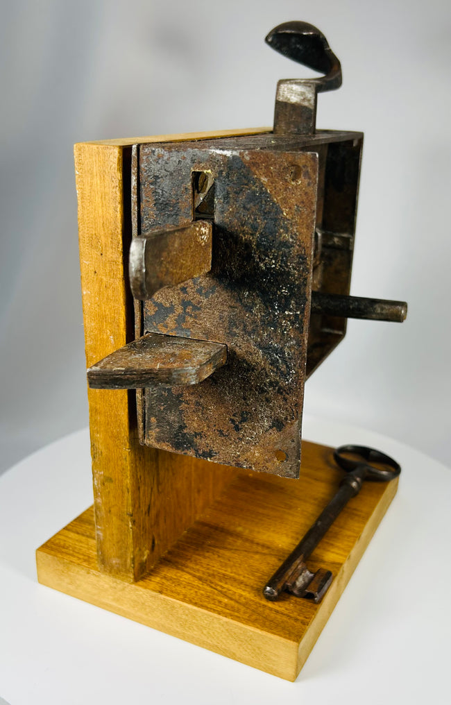 Antique security lock with exposed internal components and original iron key
