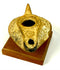 Ancient Byzantine ceramic oil lamp decorated with molded chevron patterns, diagonal lines, and a circular geometric motif.