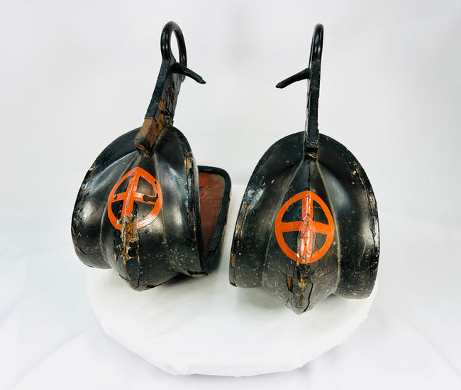 Edo–Meiji Period Japanese Samurai stirrups — lacquered wood with red cross-in-circle mon crest design. Antique equestrian artifact from Japan displayed on white background, showcasing traditional craftsmanship and patina.