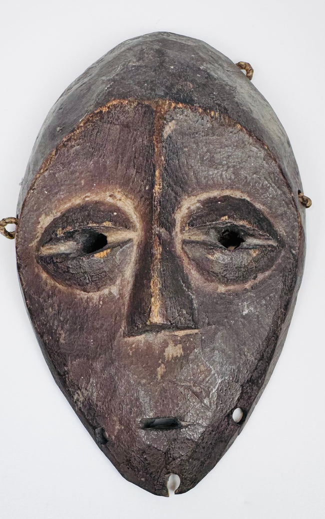 Authentic Lega passport mask featuring elongated facial form and stylized almond-shaped eyes.
