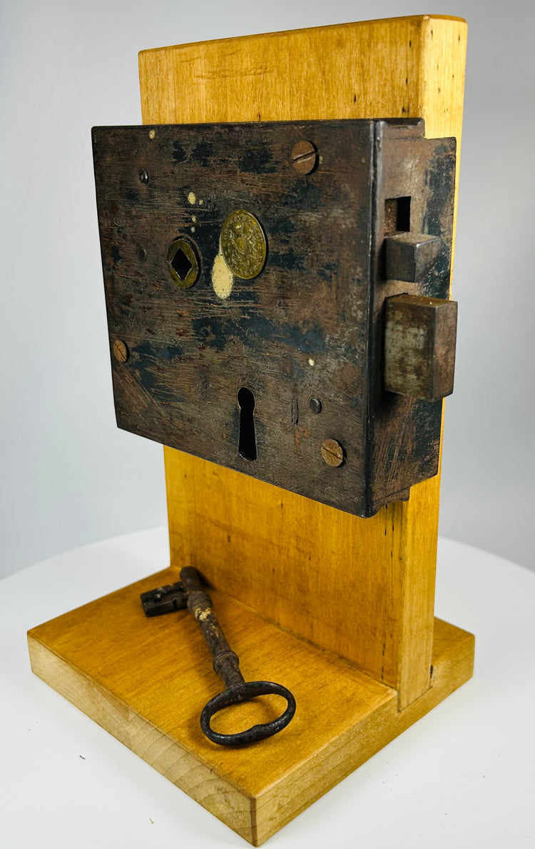Carpenter and Co rim lock mounted on display stand showing internal mechanism