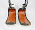 Pair of antique Japanese lacquered samurai stirrups with red interiors and black lacquered exteriors, Edo–Meiji period design, displayed on a white background.