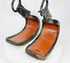Pair of antique Japanese lacquered samurai stirrups with curved red interiors and black lacquered exteriors, Edo–Meiji period craftsmanship, displayed on a white background.