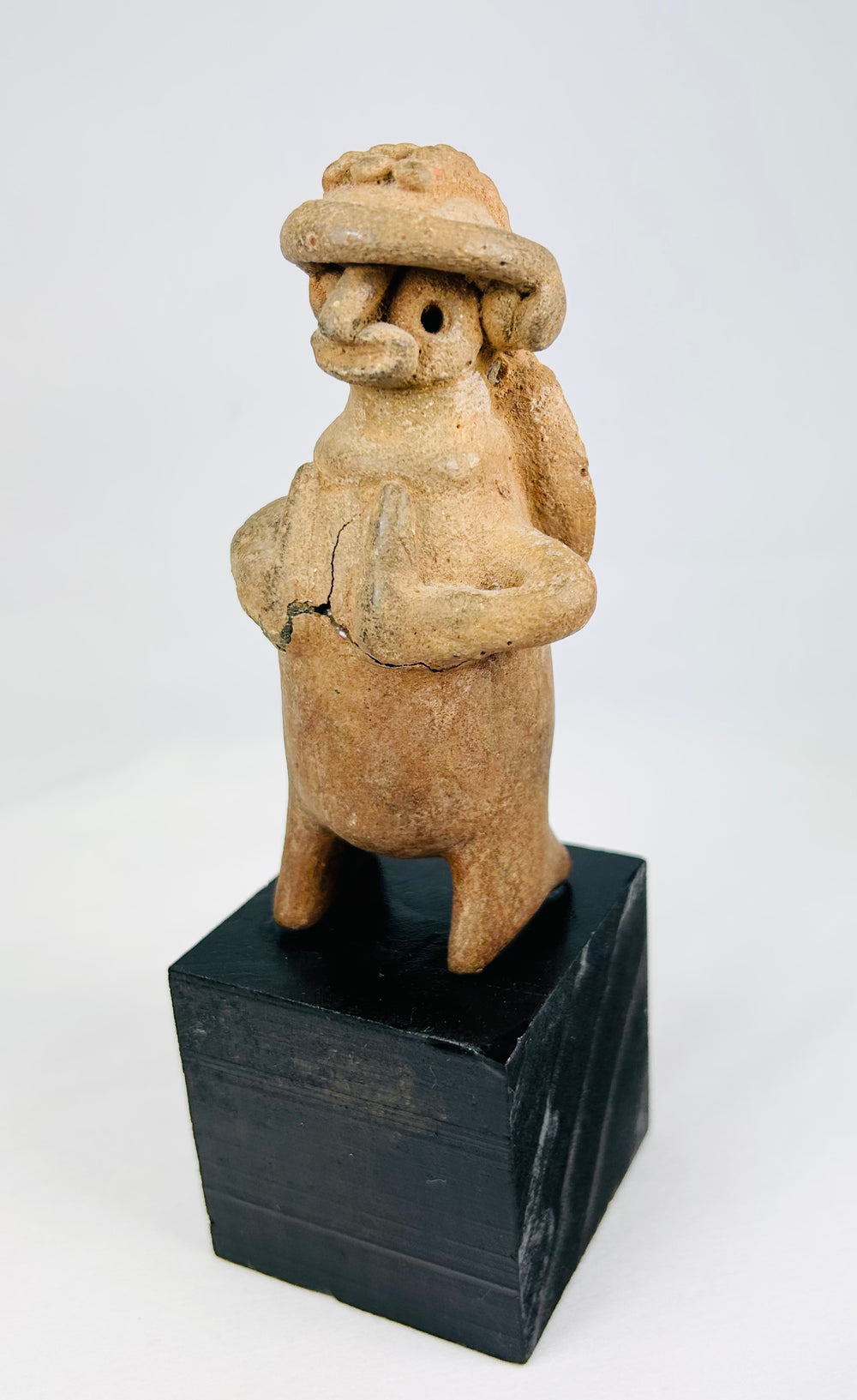 Pre-Columbian West Mexican terracotta effigy, turban headdress, perforated back disk, 100 BCE–300 CE