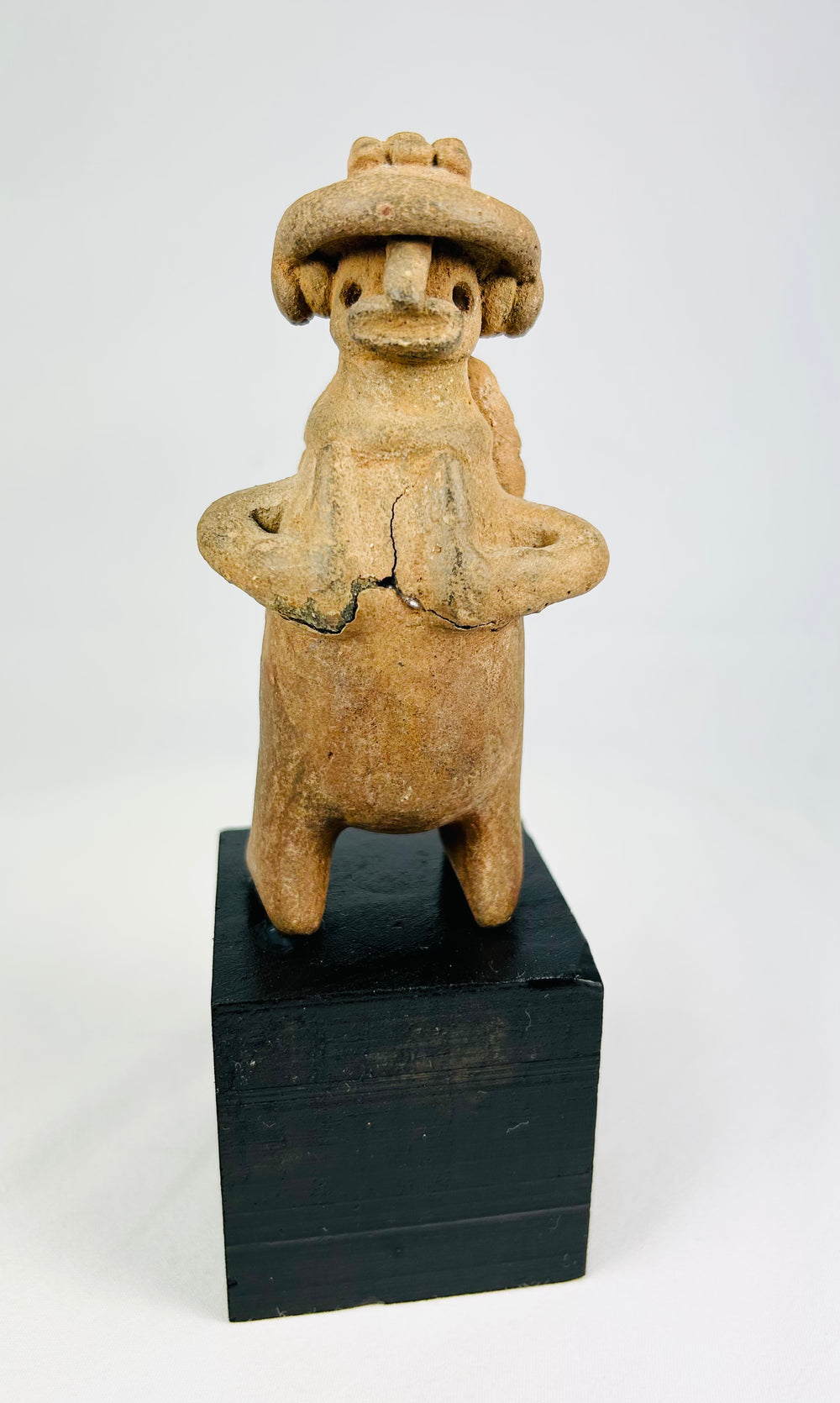 Jalisco/Nayarit standing terracotta effigy, warrior pose, earspools, circular back disk, ancient wear