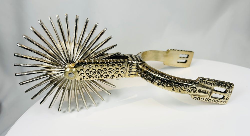 South American equestrian spurs with large rotating rowels and engraved detail