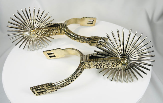 Vintage Chilean horse riding spurs with ornate metalwork and rotating rowels