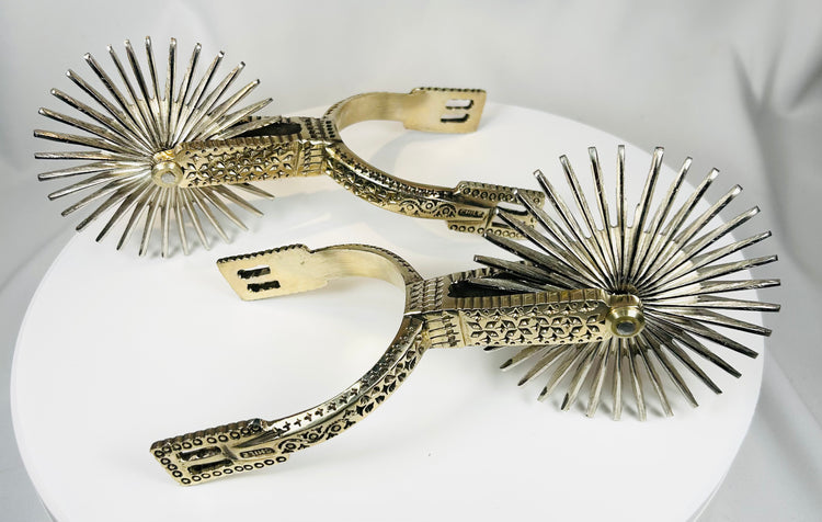 Vintage Chilean horse riding spurs with ornate metalwork and rotating rowels