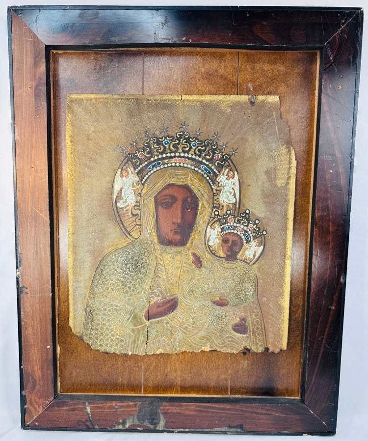 Black Madonna devotional icon with embossed metal revetment, jeweled crowns, and decorative halo motifs.