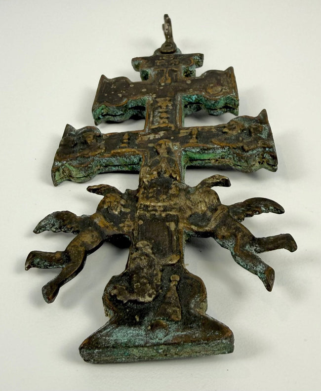 Reverse decoration of an antique Spanish Cross of Caravaca featuring religious figures and symbols associated with the legendary Miracle of Caravaca.