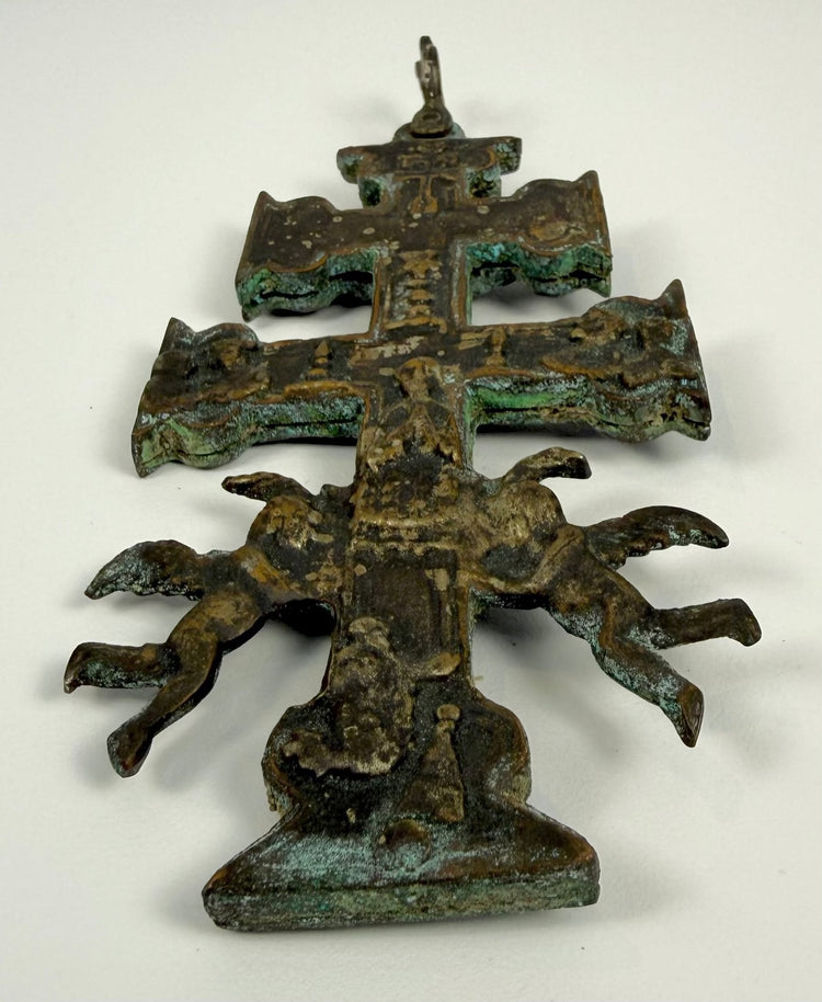 Reverse decoration of an antique Spanish Cross of Caravaca featuring religious figures and symbols associated with the legendary Miracle of Caravaca.